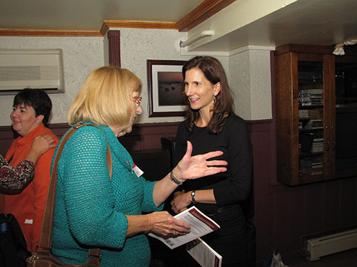 Karen speaks with a woman at an event